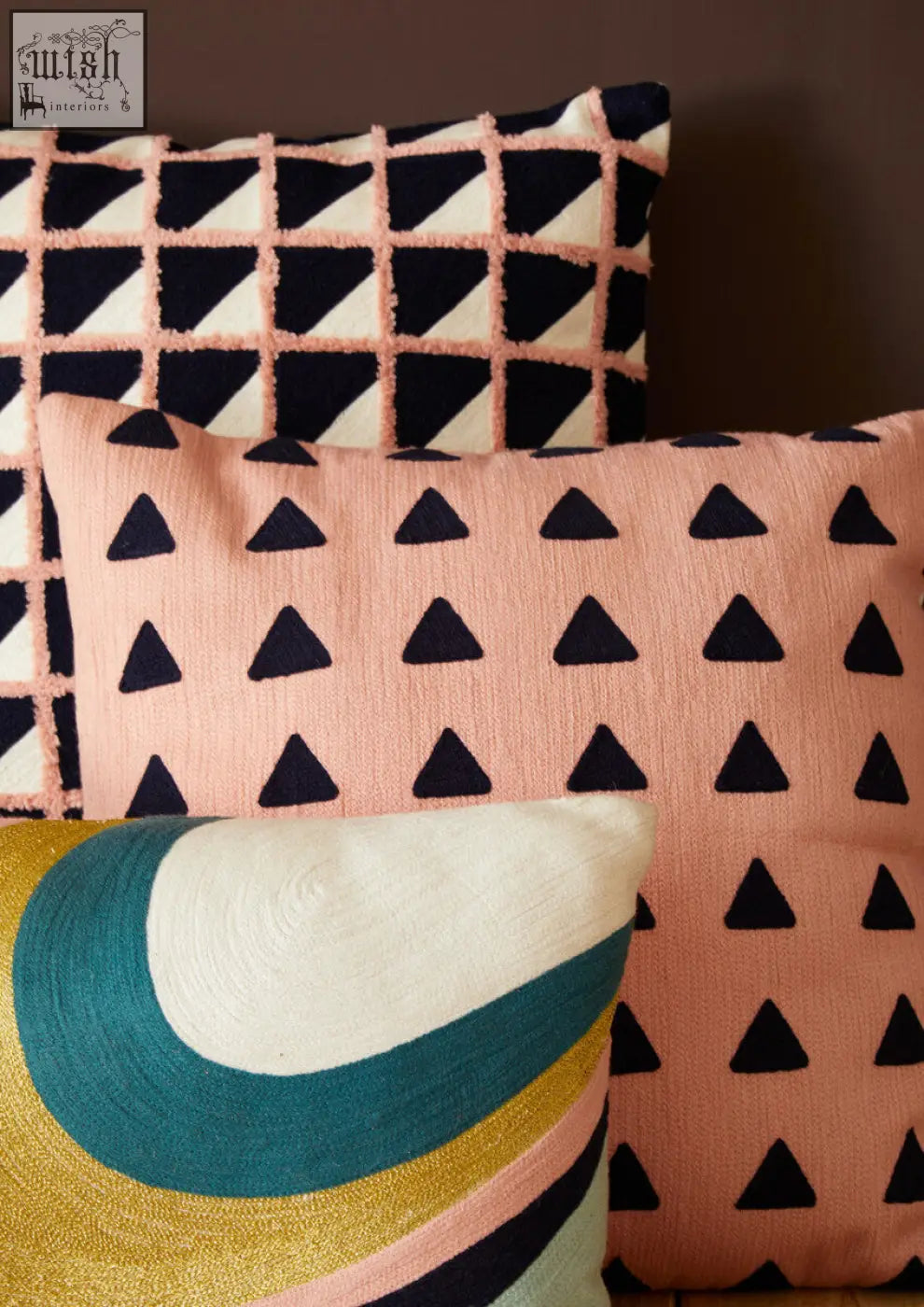 Pastel pink bosie ozella curved stripes cushion with black triangular embroidery and textured woven fabric finish