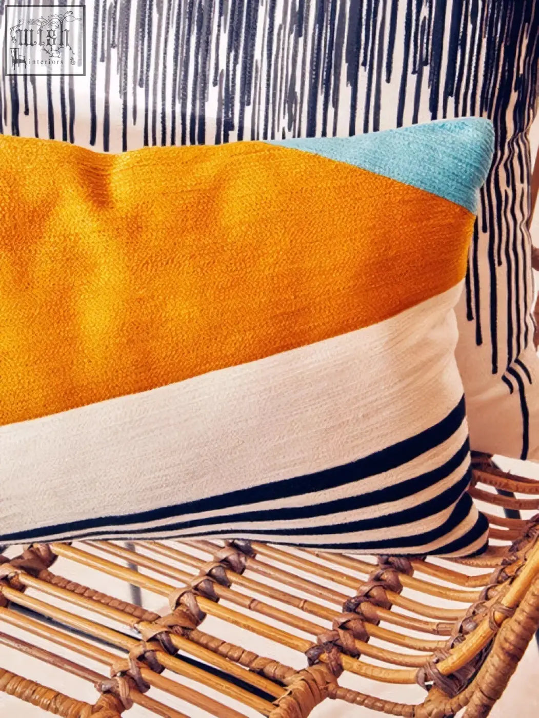 Vibrant bosie ozella diagonal design cushion with orange cream teal and bold navy stripes in a diagonal design