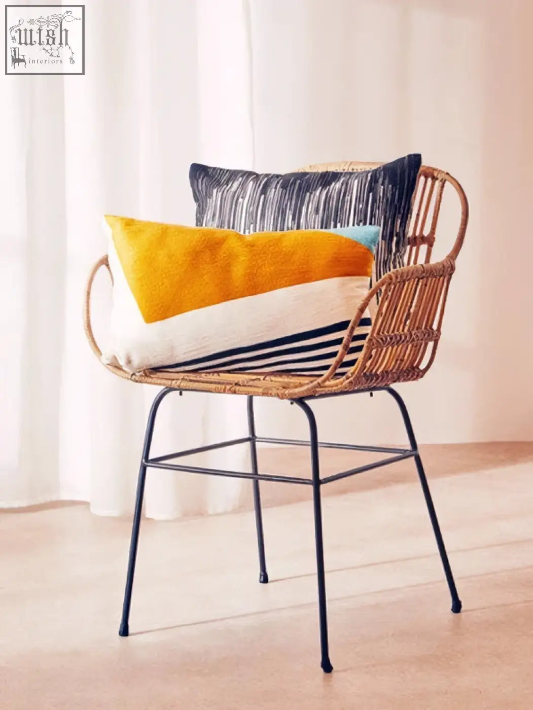 Woven rattan chair with black metal legs featuring bosie ozella diagonal design cushion in three colorful throw pillows