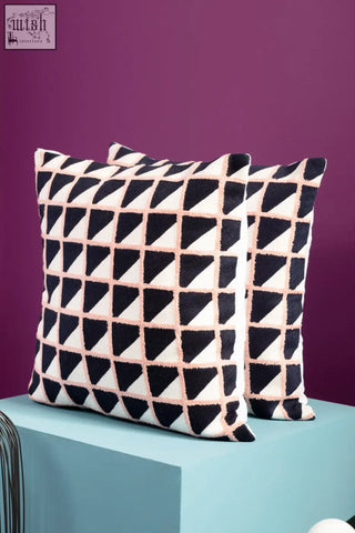 Black and white Bosie Ozella grid design cushion with geometric pattern and pink stitching accents on throw pillows