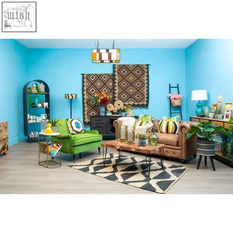 Green upholstered sofa with bosie ozella hexagonal design cushion featuring circular patterns and gold-tone metal legs