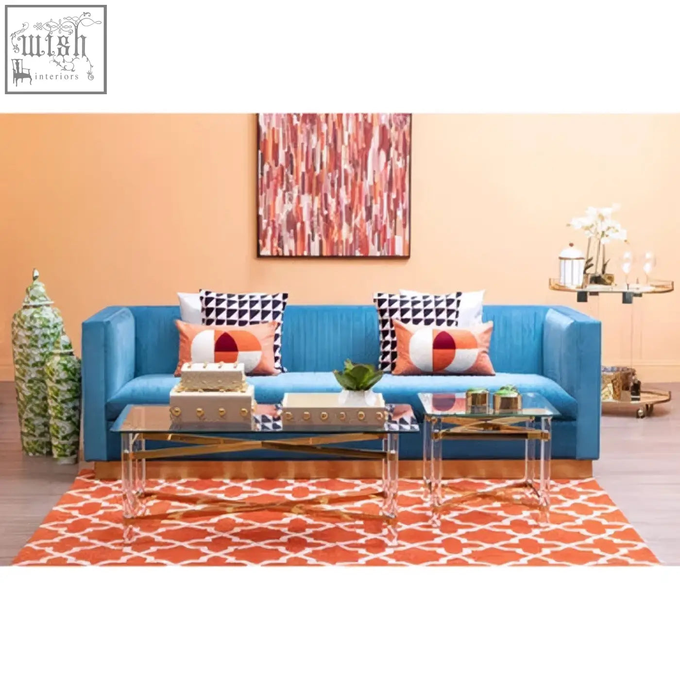 Bright blue sofa with sleek modern design and bosie ozella multicolour rectangular cushion featuring geometric patterns