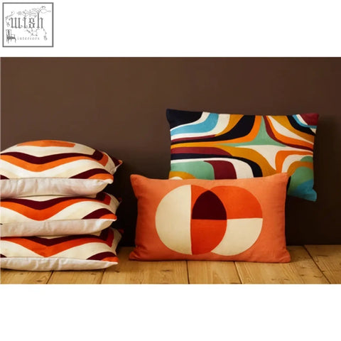 Orange pillow featuring bold white and red circular design on bosie ozella multicolour rectangular cushion