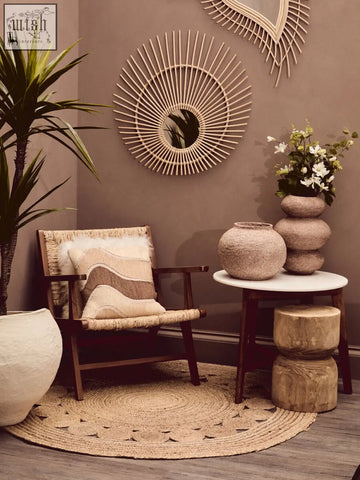 Beige woven rattan armchair with wooden frame and natural tonal cushion featuring wavy earth-toned stripes