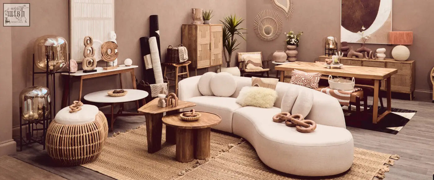 Cream-colored curved sectional sofa with plush natural tonal cushions in minimalist bosie ozella design