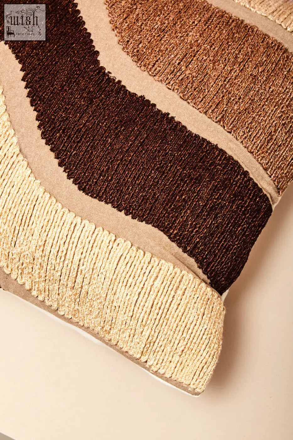 Bosie ozella natural tonal cushion with a textured woven finish and wavy stripes in beige brown and tan tones