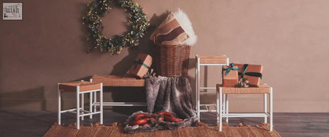 Woven wicker basket with bosie ozella natural tonal cushion striped with fluffy white trim on top