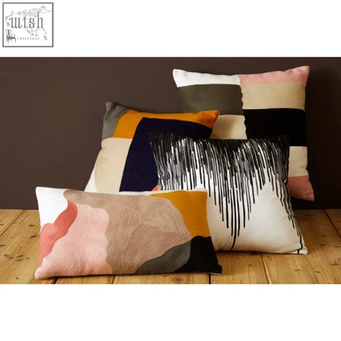 A bosie ozella patch design cushion featuring modern abstract patterns in soft pastels and bold earth tones