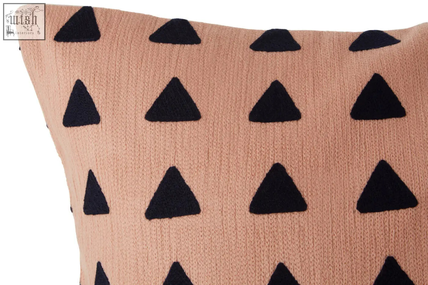 A bosie ozella pink knit cushion featuring a blush pink base with black embroidered triangle patterns