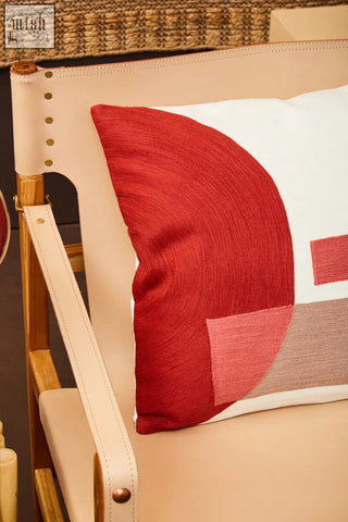 A modern bosie ozella red and white tonal cushion with bold geometric patches in textured fabric design