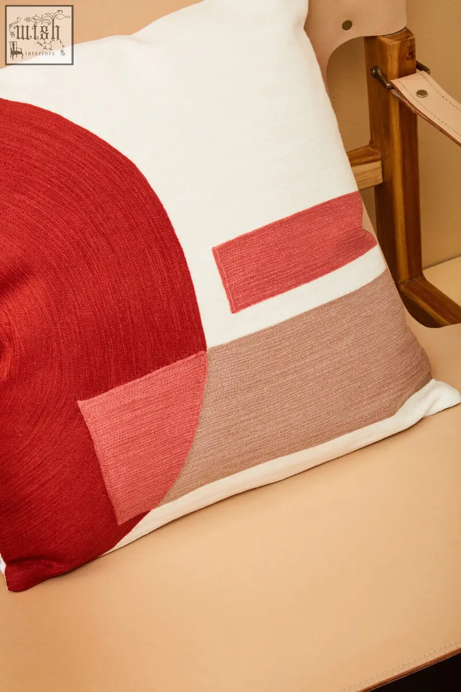 Bosie ozella red and white tonal cushion with bold red coral and beige geometric patches on a white tonal base