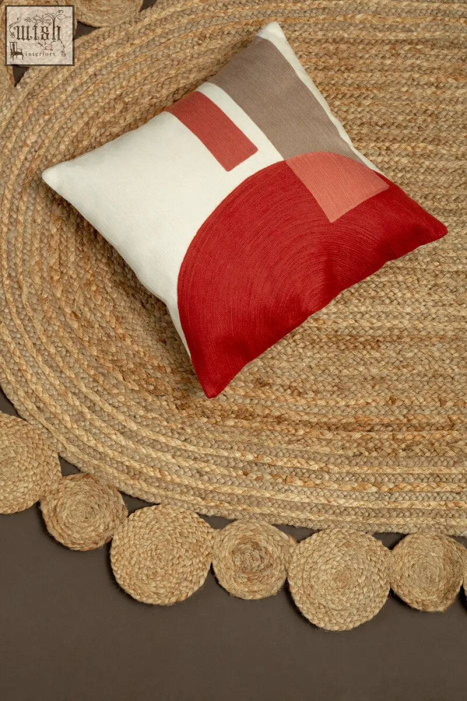 A bosie ozella red and white tonal cushion with bold geometric shapes on soft fabric perfect for modern decor