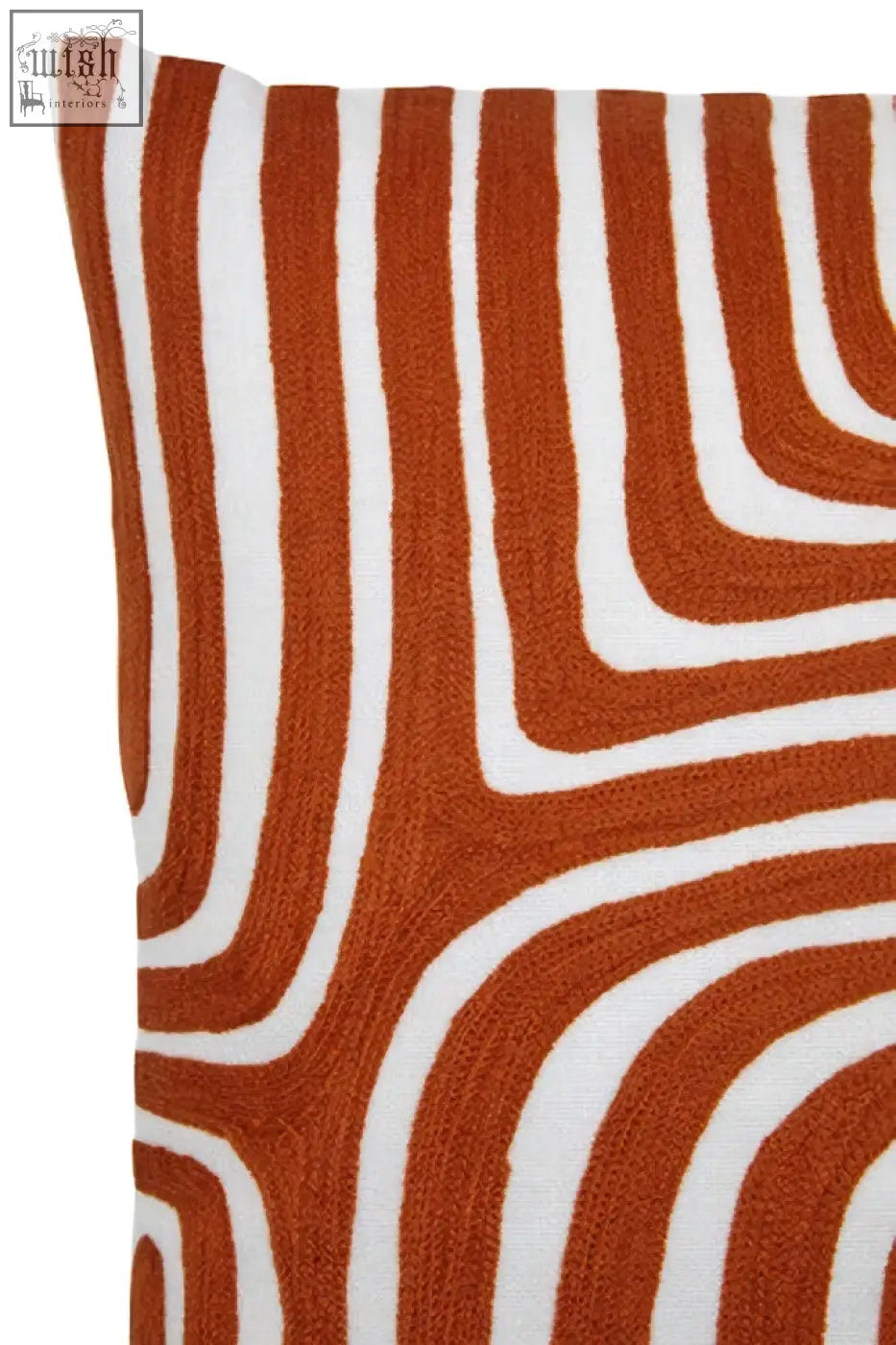 A bosie ozella premium cotton white cushion with bold curved stripes on a rust orange background