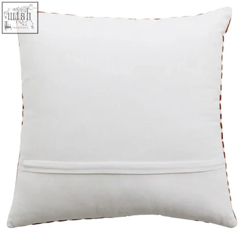 White cushion bosie ozella with subtle brown stitching and intricate embroidery on rust and white fabric