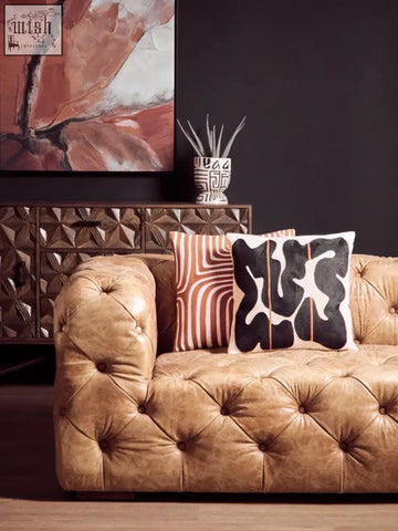 Tan tufted leather sofa with bosie ozella rust and white cushion featuring premium cotton white cushion accents