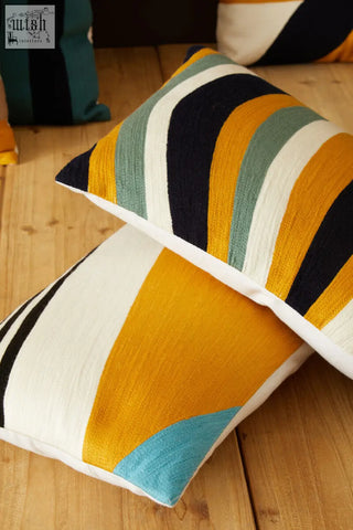 Vibrant bosie ozella stripes design cushion with bold yellow navy teal and white geometric patterns in textured fabric