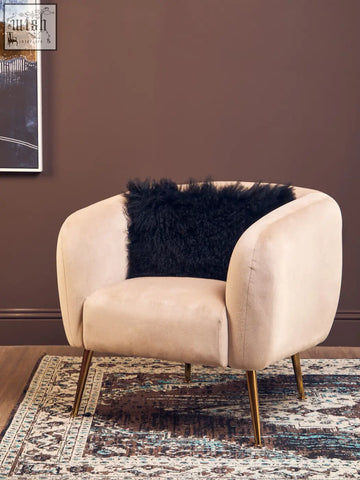 Cream-colored velvet armchair with gold-tone legs and bosie real mongolian fur black rectangular cushion