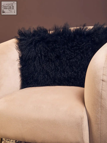 Black fluffy bosie real mongolian fur rectangular cushion on beige armchair with soft mongolian fur black texture