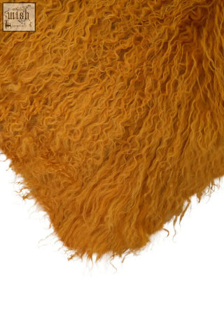 Bosie real mongolian fur ochre square cushion with plush golden-orange mongolian lamb fur and dense curly texture