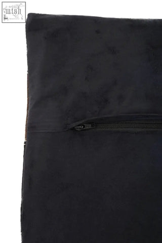 Black suede garment bag with horizontal zipper closure shown alongside bosie safira neutral colourblock leather patchwork cushion