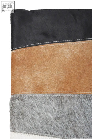 Black tan and gray bosie safira hair on leather patchwork cushion with stitched horizontal stripes for cozy style