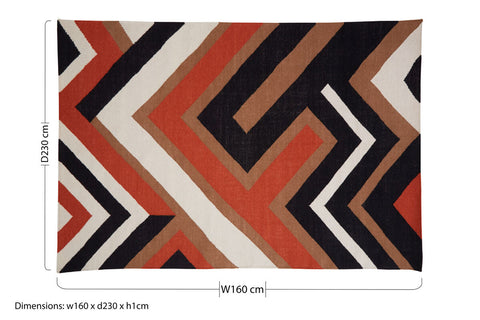 A rectangular bosie villon zig zag pattern rug with bold black orange white and tan geometric zigzag design