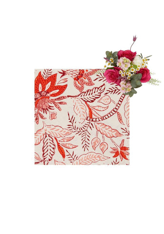 A bossa nova table napkin set of 4 with vibrant red and pink botanical print and artificial rose bouquet on off white background