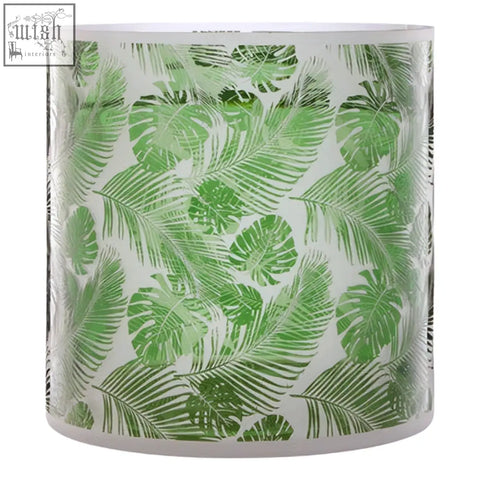 Botanical large hurricane candle holder with white base and rim featuring green tropical leaf pattern on glass large hurricane candle