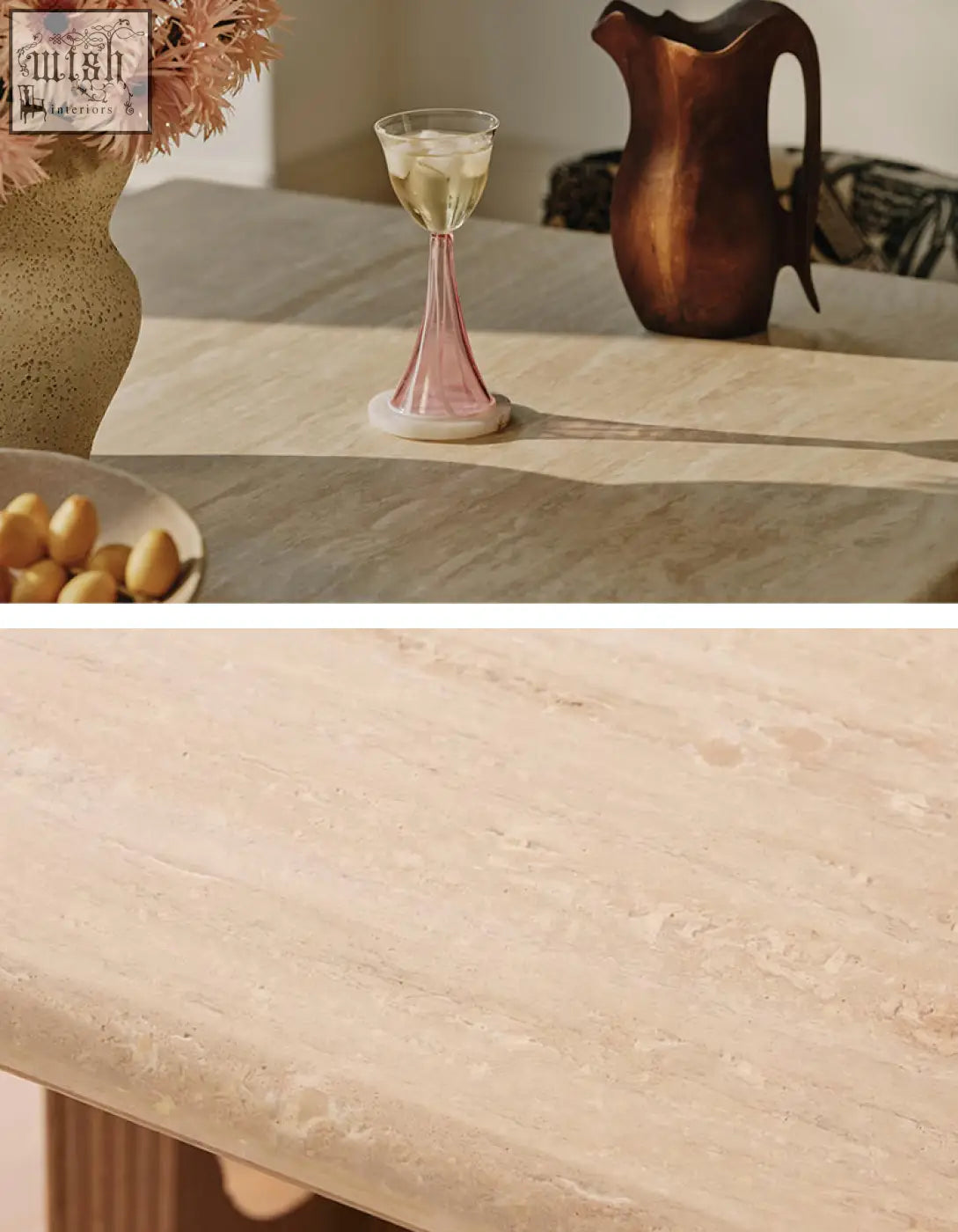 A delicate pink glass wine goblet with white wine on a travertine and solid wood dining table in a dining area
