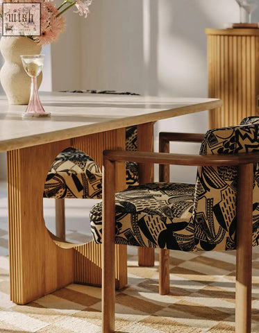 Wooden chair with black and beige geometric upholstery paired with boucheron travertine marble dining table for dining area