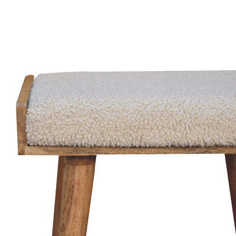 Boucle cream tray style footstool with cream sheepskin textured cushion and natural wood frame and legs
