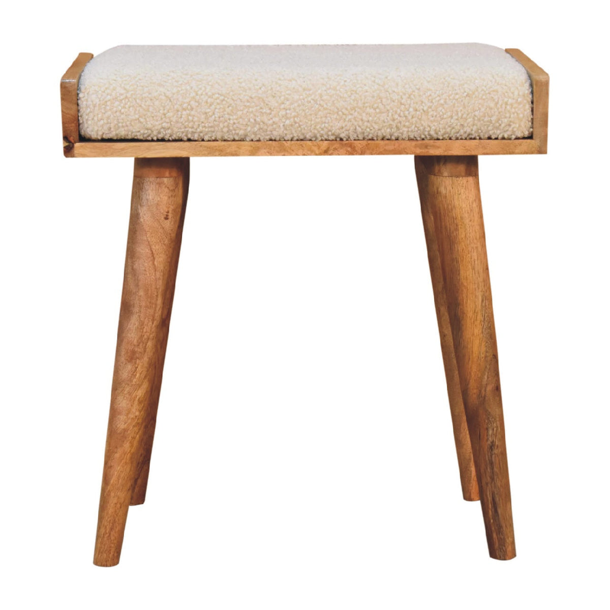 A cozy beige sheepskin cushioned boucle cream tray style footstool with natural wood frame and tapered legs