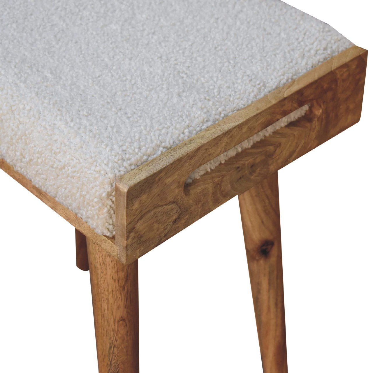 A cozy tray style footstool with a white sheepskin cushion and natural wood frame with tapered legs