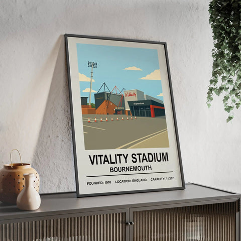A framed bournemouth vitality stadium print with bold black text and colorful stadium illustrations under a blue sky