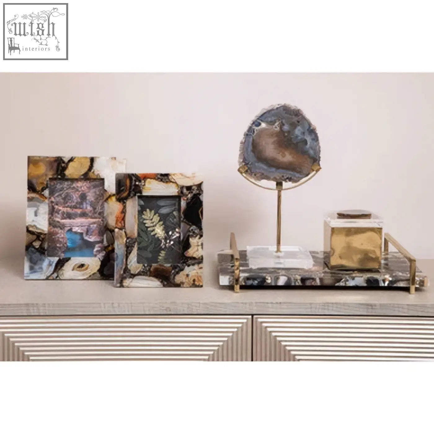 A polished blue and gold bowerbird black agate trinket box on a metal stand perfect for storing small items