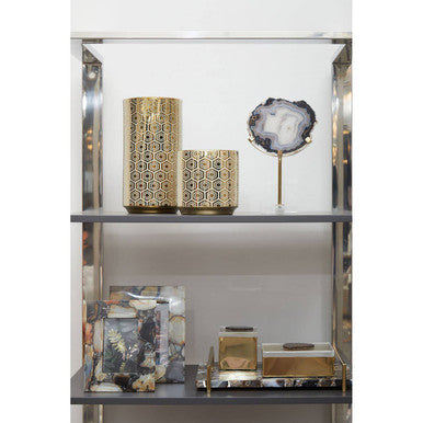 Gold geometric-patterned cylindrical vases complementing the bowerbird black and gold agate sculpture display