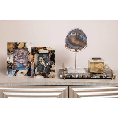 Polished bowerbird black and gold agate sculpture with shimmering blue and gold interior on metal stand gold agate sculpture