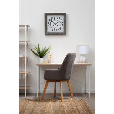 Gray framed wall clock with black numerals on a bradbury natural oak top desk showcasing natural oak style
