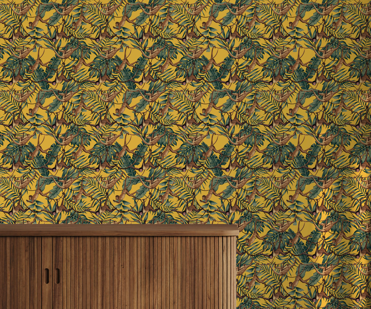 Bright yellow bradley wallpaper with green tropical leaves and brown monkeys swinging in dense repeating pattern
