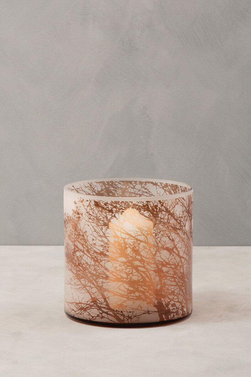 Branch medium glass hurricane candle holder with frosted glass and copper tree branch patterns holding a lit white candle