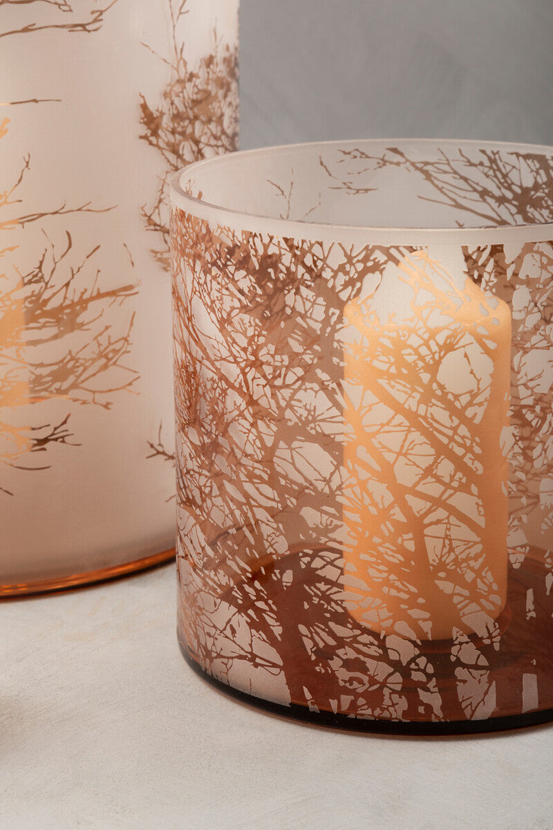 A frosted medium glass hurricane candle holder with etched golden-brown tree branch design for cozy lighting