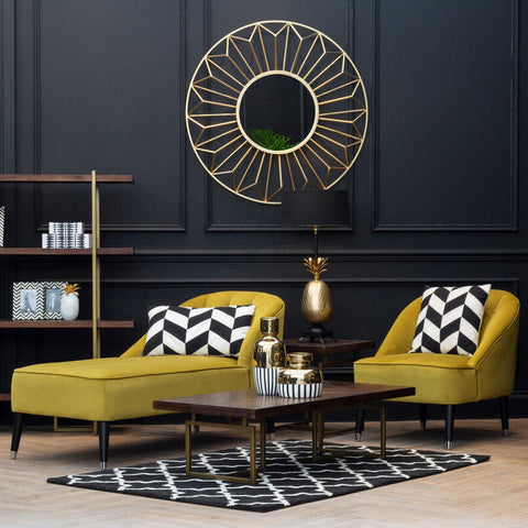Gold geometric sunburst mirror with circular center and radiating triangular facets perfect for wall decor