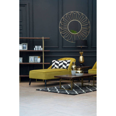 Yellow velvet chaise lounge with black and white geometric pillow next to brando acacia wood effect coffee table
