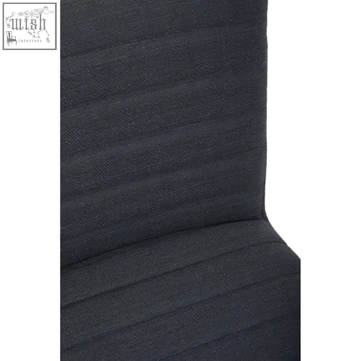 Back of a charcoal grey dining chair with dark gray textured fabric and vertical ribs featuring oak legs
