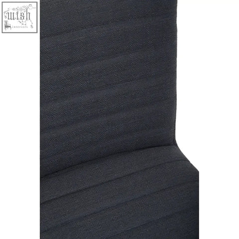 Back of a charcoal grey dining chair with dark gray textured fabric and vertical ribs featuring oak legs