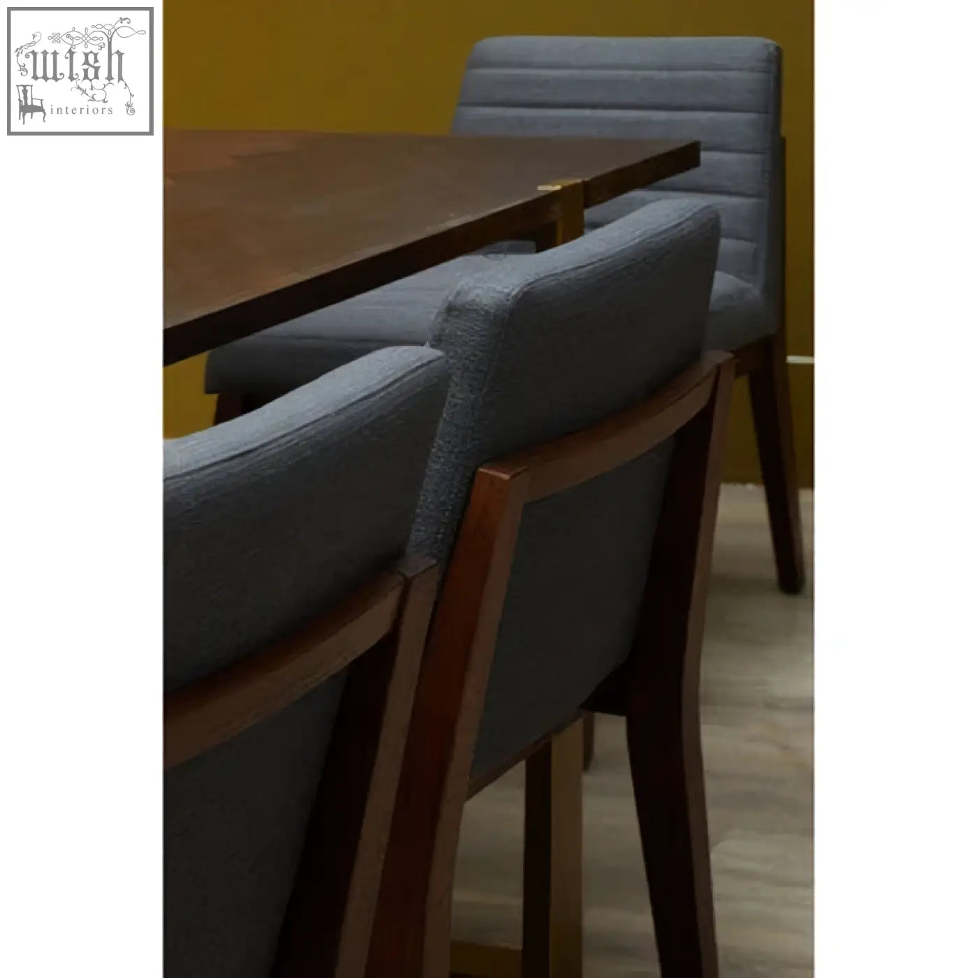 Gray dining chair with charcoal grey upholstery and oak legs featuring a dark wood frame for stylish dining rooms