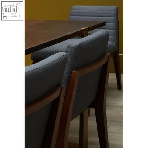 Gray dining chair with charcoal grey upholstery and oak legs featuring a dark wood frame for stylish dining rooms
