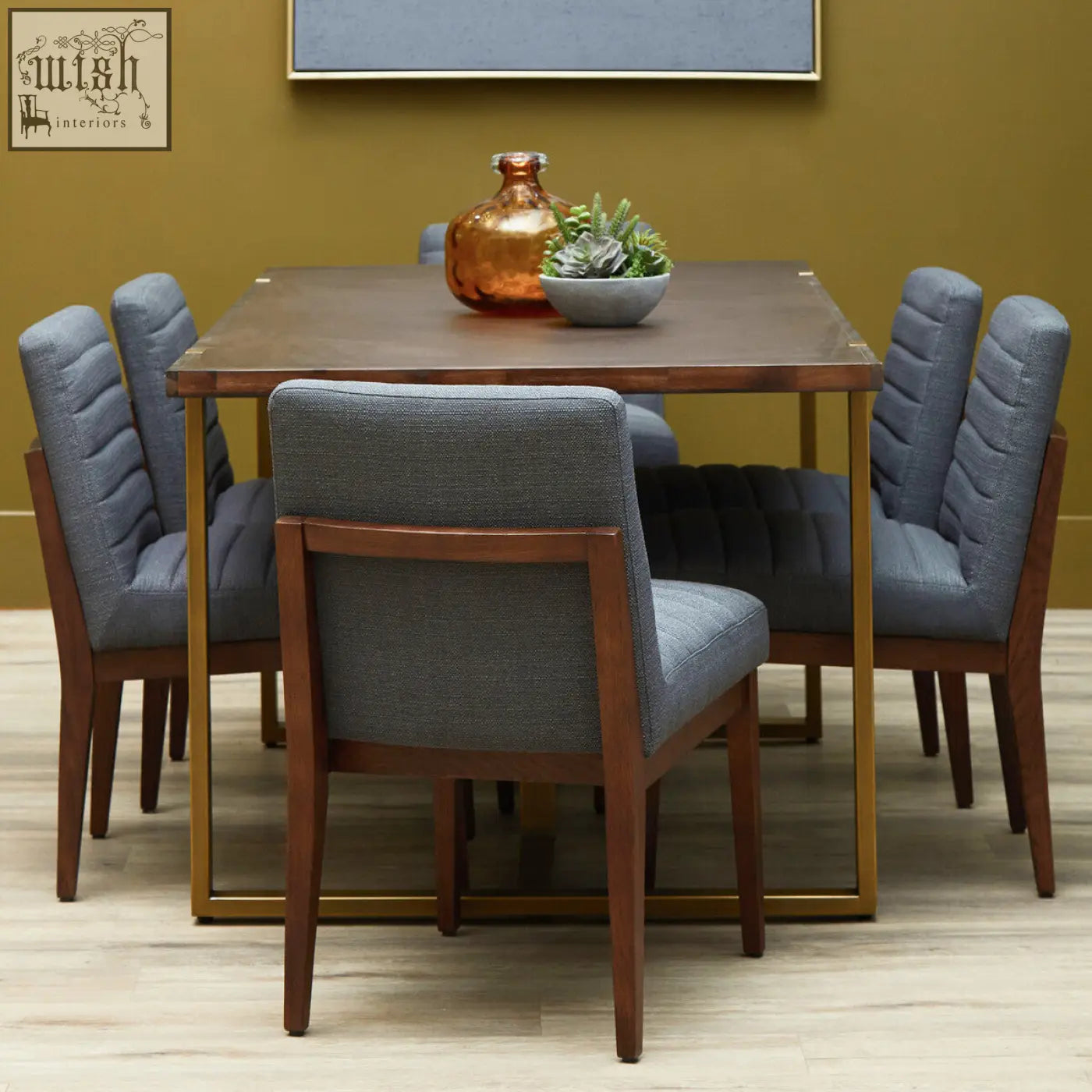 Modern dining set with charcoal grey dining chairs and oak legs around a dark wood table with gold-tone metal legs