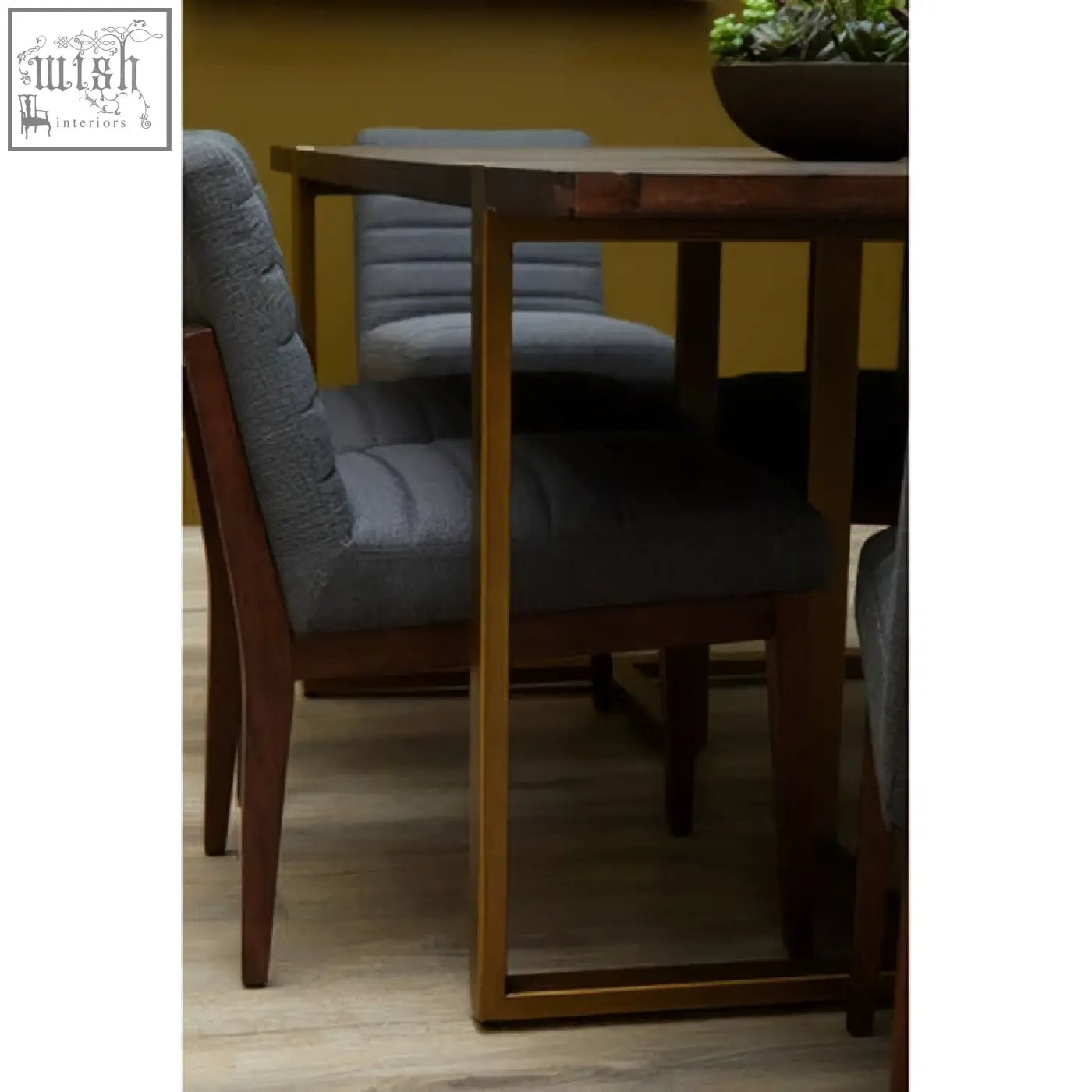 Modern dining table with dark wood top paired with brando charcoal grey dining chair with oak legs and sleek gold legs