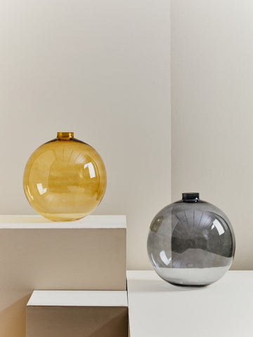 Amber and grey spherical glass vases with reflective surfaces featuring bree grey glass vase design